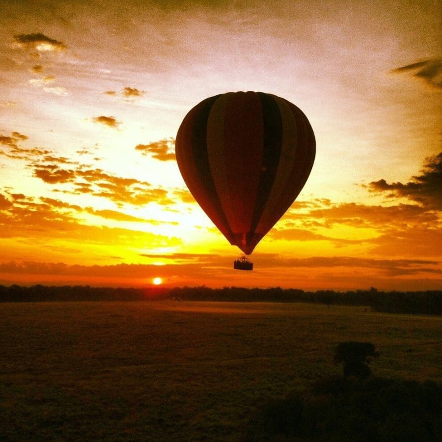 Air balloon flying over a sunset